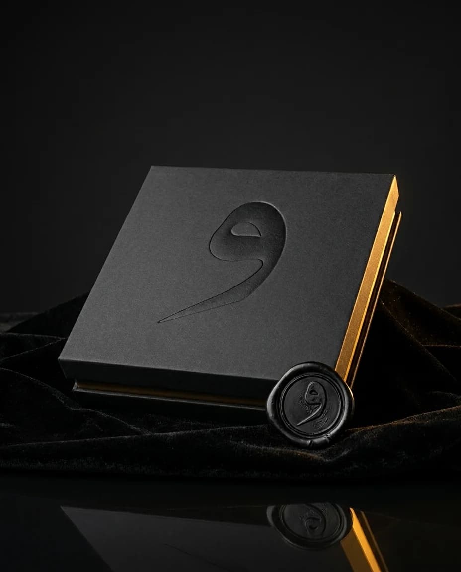 The vao box — matte black, blind-debossed letter, wax-sealed sanad